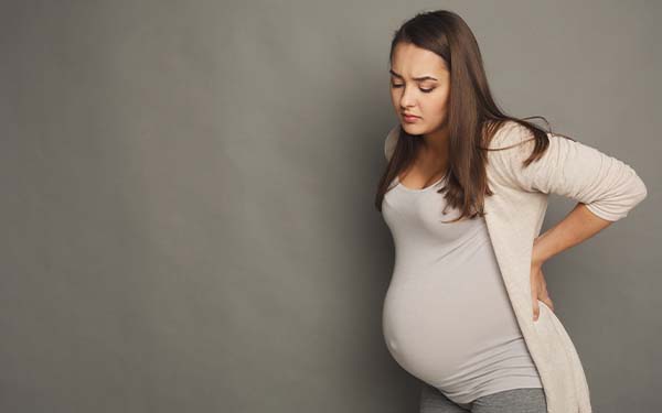 Pregnant woman alone, looking down