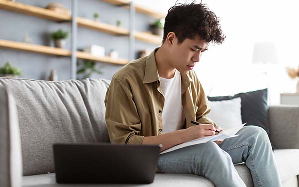 young man signing papers