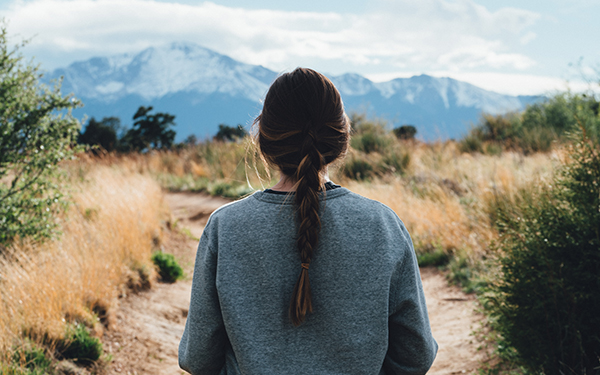 woman looking out at the colorado mountains